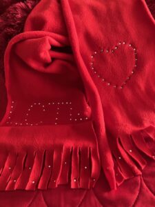 Love Changing the World Inc. Scarf with LCTW and heart logo.