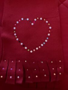 Love Changing the World Inc. Scarf with heart logo. 