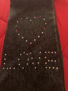 Love Changing the World Inc. Scarf with heart logo and love. 